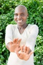 young african woman with shaved head, cancer patient, gesturing stay away