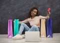 Young african woman shopping online at home Royalty Free Stock Photo