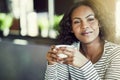 Young African woman sitting in a cafe deep in thought Royalty Free Stock Photo