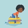 Young african woman trying to close a suitcase. Royalty Free Stock Photo