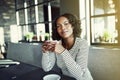 Young African woman smiling while enjoying coffee in a cafe Royalty Free Stock Photo