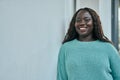 Young african woman smiling happy leaning on the wall Royalty Free Stock Photo