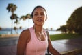 Sporty young woman walking down the street listening to music Royalty Free Stock Photo