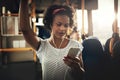 Young African woman standing on a bus listening to music Royalty Free Stock Photo