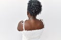 Young african woman standing over white isolated background standing backwards looking away with crossed arms Royalty Free Stock Photo