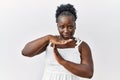 Young african woman standing over white isolated background doing time out gesture with hands, frustrated and serious face Royalty Free Stock Photo