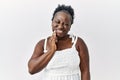 Young african woman standing over white isolated background touching mouth with hand with painful expression because of toothache Royalty Free Stock Photo