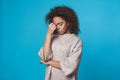 Young african woman studio portrait isolated on blue