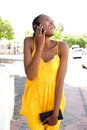 Young african woman in summer dress talking on cell phone Royalty Free Stock Photo