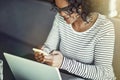 Young African woman using a laptop and reading text messages Royalty Free Stock Photo