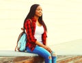 Young african woman wearing a red checkered shirt and backpack Royalty Free Stock Photo