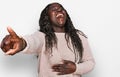 Young african woman wearing wool winter sweater laughing at you, pointing finger to the camera with hand over body, shame Royalty Free Stock Photo