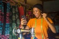 African woman who is a tailor feeling excited and happy and jubilant while viewing content on her mobile phone
