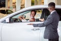 African woman surprised by new car, gift for my beautiful wife Royalty Free Stock Photo