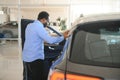 young africanamerican man came to see automobiles in dealership or cars showroom