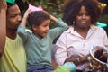 Young afro-american boy playing with plastic sword