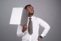 Young afro american businessman using laptop and taking notes. Royalty Free Stock Photo