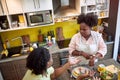 Young afro-american couple arguing about being late at dinner table in the kitchen