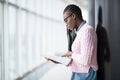 Young beauty afro american girl student in glasses reading notebooks and studying new object before lecture in modern University Royalty Free Stock Photo