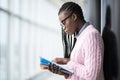 Young beauty afro american girl student in glasses reading notebooks and studying new object before lecture in modern University Royalty Free Stock Photo