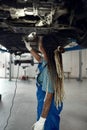 Young afro american girl techician at car service station