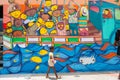 Young Afro-American girl walks by wall art image of truck loaded