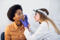 Young afro american lady patient at modern ENT clinic. Professional female doctor otorhinolaryngologist doing nose Royalty Free Stock Photo