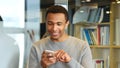 Young Afro-American Man Browsing Online on Smartphone