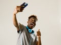 Young afro american man smiling happy taking selfie self portrait picture with mobile phone Royalty Free Stock Photo