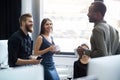 Young afro american man speaking to two of his colleagues Royalty Free Stock Photo