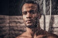 Young Afro-American Man Taking Shower in Bathroom. Royalty Free Stock Photo