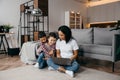 Young afro american mom with two sons make video call by laptop with their daddy. Remote family relationship concept