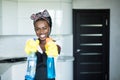 Portrait young african woman using spray to wipe windows glass Royalty Free Stock Photo