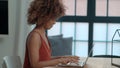 Young Afro American woman using laptop computer while sitting at table. Royalty Free Stock Photo