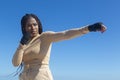 Young afro girl training martial arts, boxing outdoors with sea and blue sky background. Attitude, sport, workout Royalty Free Stock Photo