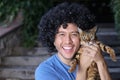 Young afro hair guy with a bengal cat