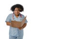 young Afro-Latin doctor woman writing and reading medical files in a folder, white background Royalty Free Stock Photo