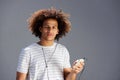 Young afro man with earphones and cellphone