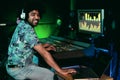 Young Afro man working in music recording studio - Male audio engineer mixing a sound inside production house