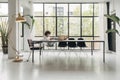 Young african american woman relaxing. Sitting behind desk writing notes. Legs up on the table. Spacious loft apartment.