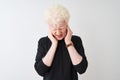 Young albino blond man wearing black t-shirt standing over isolated white background with hand on head for pain in head because Royalty Free Stock Photo