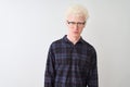 Young albino blond man wearing casual shirt and glasses over isolated white background depressed and worry for distress, crying Royalty Free Stock Photo