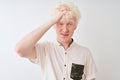 Young albino blond man wearing casual shirt standing over isolated white background stressed with hand on head, shocked with shame Royalty Free Stock Photo