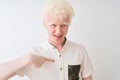 Young albino blond man wearing casual shirt standing over isolated white background with surprise face pointing finger to himself Royalty Free Stock Photo