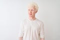 Young albino blond man wearing casual t-shirt standing over isolated white background smiling looking to the side and staring away Royalty Free Stock Photo