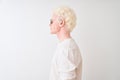 Young albino blond man wearing t-shirt and sunglasses over isolated white background looking to side, relax profile pose with Royalty Free Stock Photo