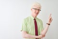 Young albino businessman wearing shirt and tie standing over isolated white background with a big smile on face, pointing with Royalty Free Stock Photo