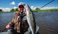 Young amateur angler holds zander fish Royalty Free Stock Photo