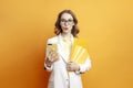 young amazed business girl in glasses and white suit holds documents and uses smartphone on colored background Royalty Free Stock Photo