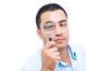 Young amazed man looking with magnifier